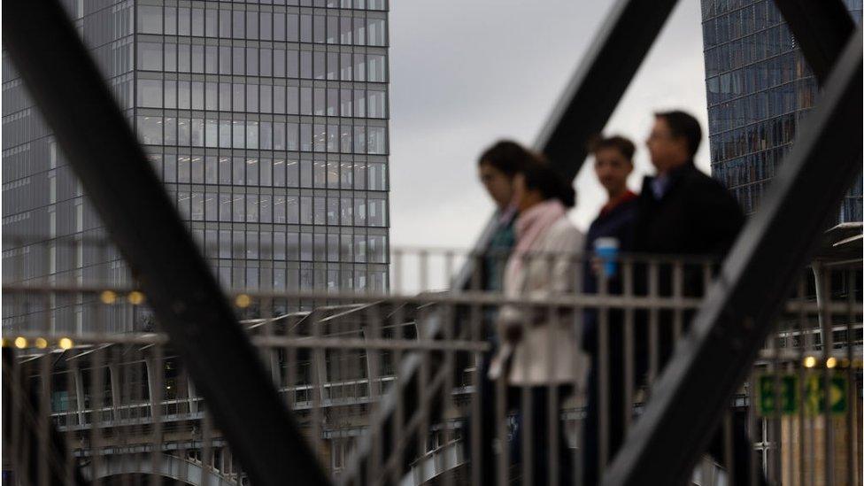 City workers walking past empty office