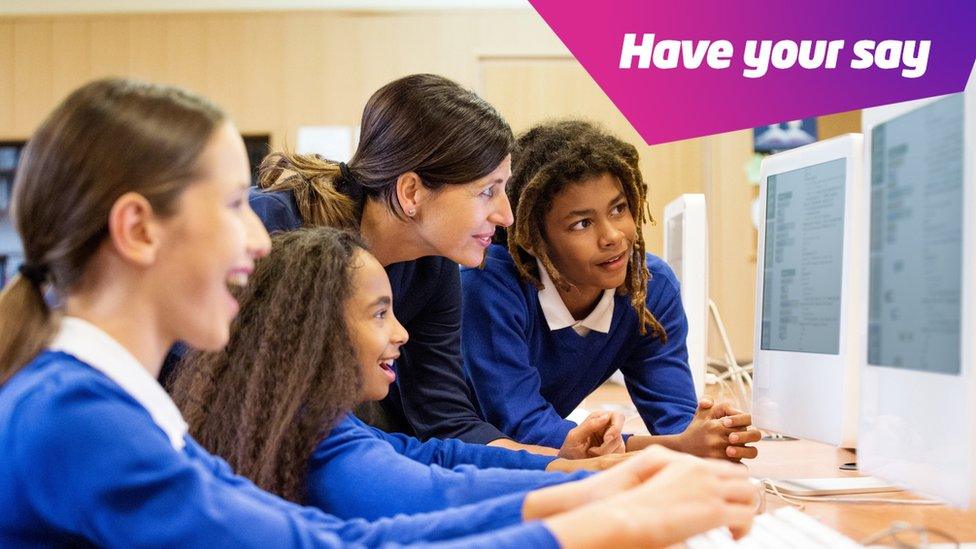 school-pupils-and-teacher-looking-at-computer.