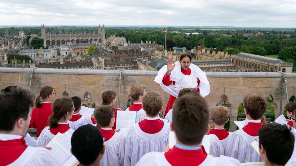 The St John's choir performs on the top of the chapel's tower