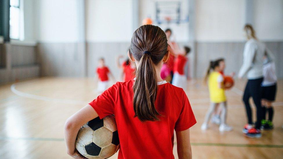 Girl holding a football