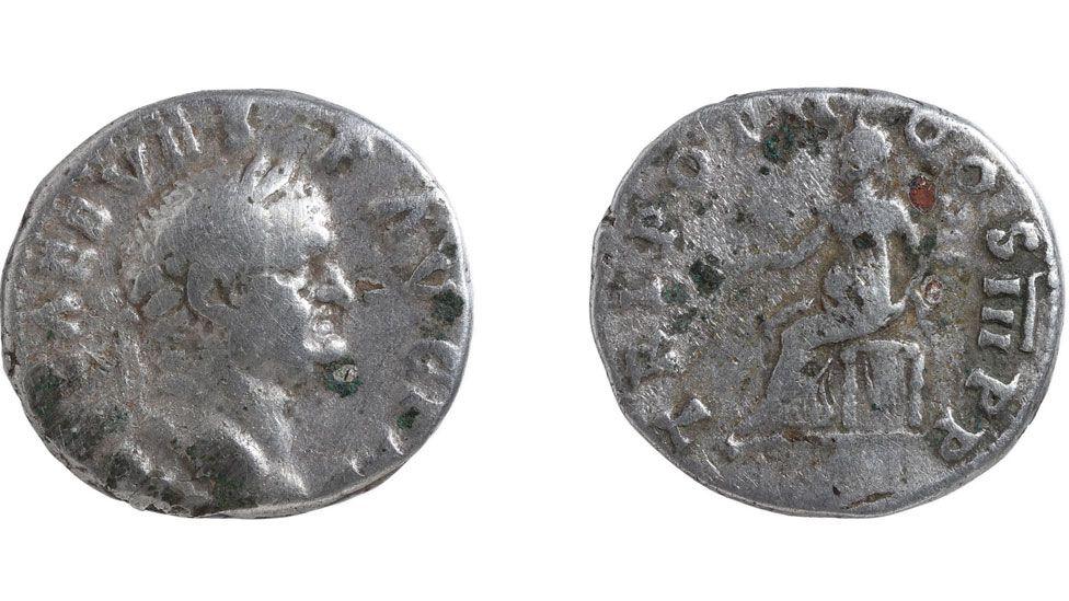 The front and back of a silver Roman coins. Emperor Vespasian, in profile and facing him is the back of the coin showing the seated goddess Pax. It dates to AD70 to 2.