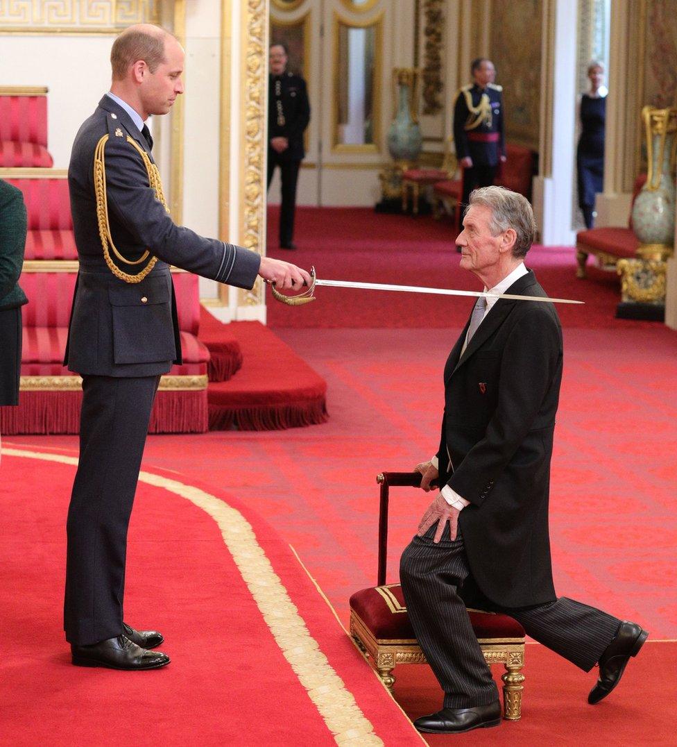 The Duke of Cambridge knighting Michael Palin