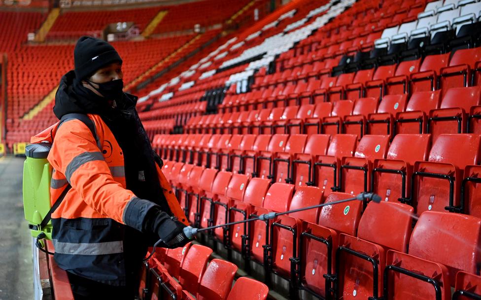 Stadium staff disinfect seats, following the Charlton Athletic v Milton Keynes Don match at The Valley