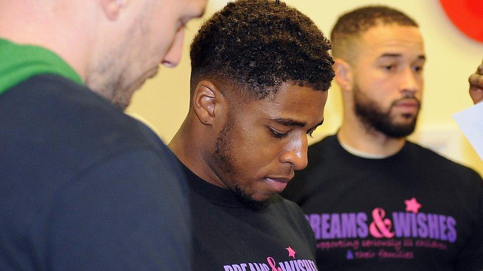 Cardiff City player Kadeem Harris (centre) was one of many stars who toured the wards