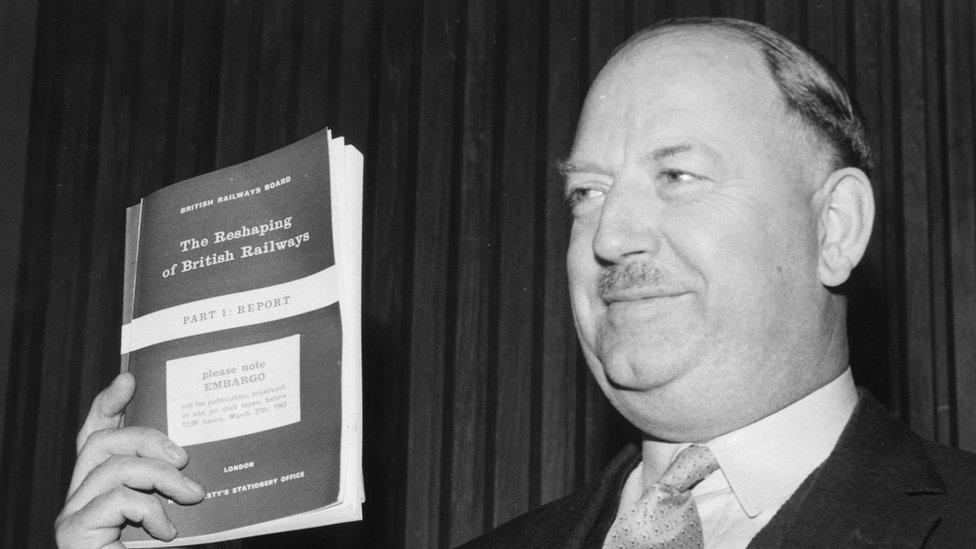 Dr Richard Beeching brandishes a copy of his 1963 report The Reshaping of British Railways