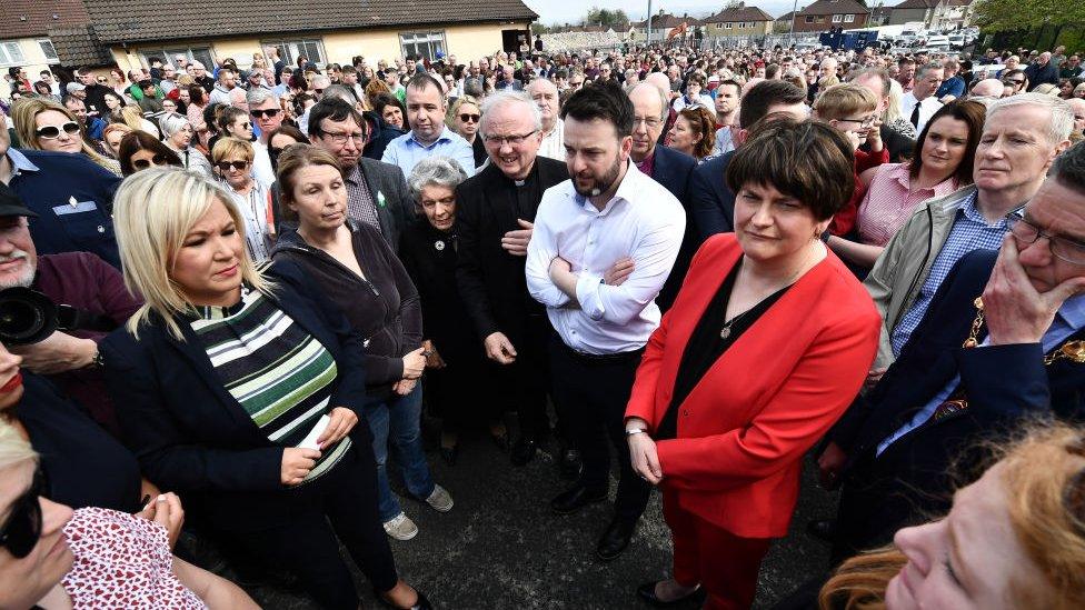 Michelle O'Neill, Vice President of Sinn Fein (2nd L), SDLP leader Colum Eastwood and Arlene Foster, leader of the DUP (3rd R) stand together as they attend a rally for journalist and author Lyra McKee