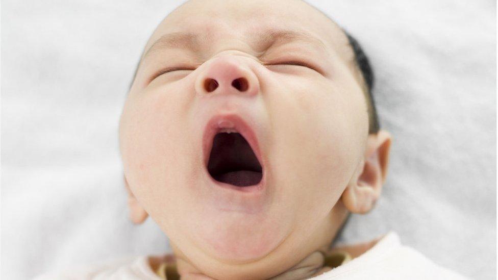 A baby yawning