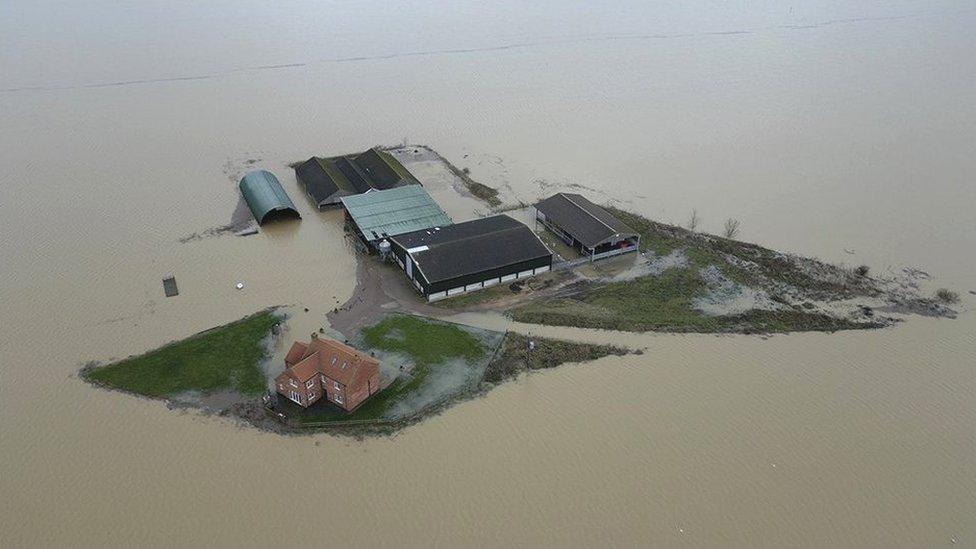 Farmhouse surrounded by water