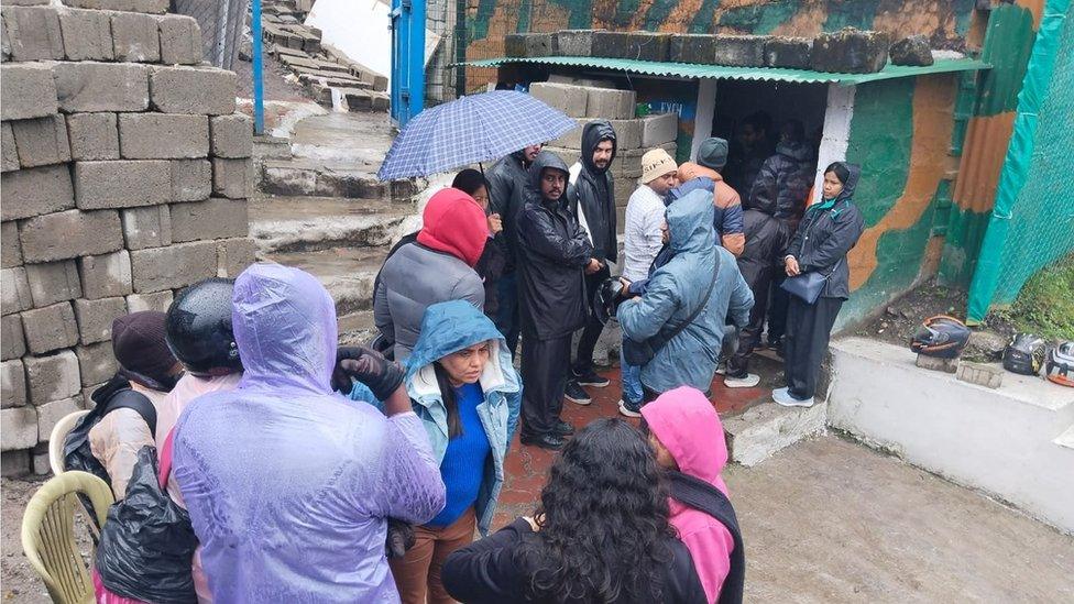 People lined up wearing raincoats