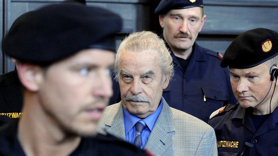 Austrian sex offender Josef Fritzl surrounded by three police officers