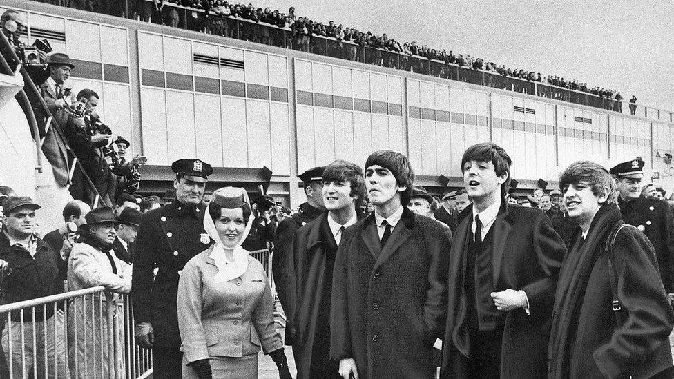 The Beatles arrive at Idlewild Airport in Queens, New York, to the sound of several hundred screaming fans