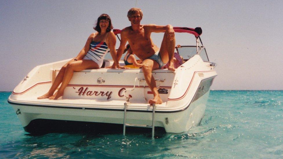 An old photo of a young couple sitting on a boat