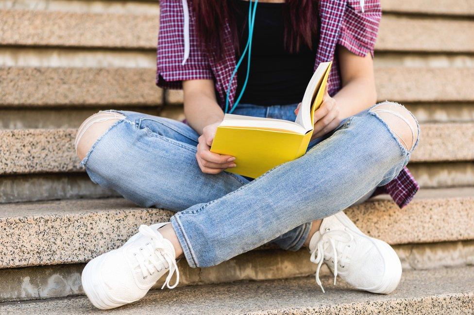 A teenage girl reading a book