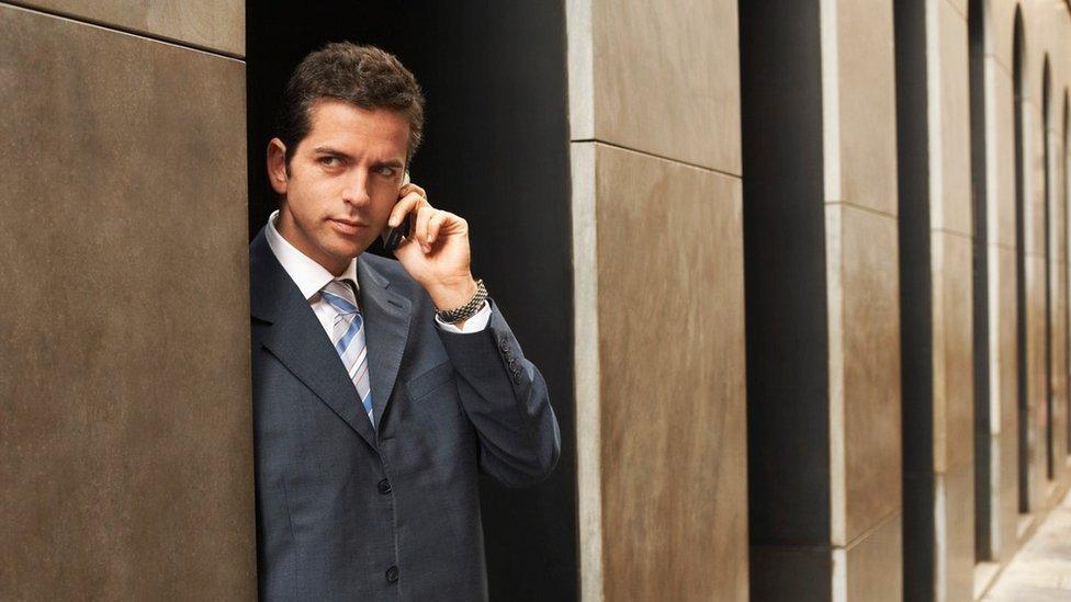 Generic shot of businessman holding phone