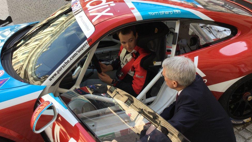 Transport minister Andrew Jones speaks to a rally driver