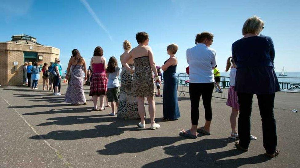 Women queuing for a public toilet in Brighton