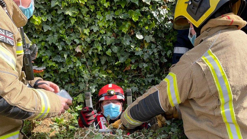 Firefighter coming out a well