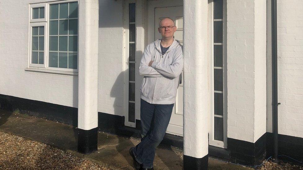 Paul Brett outside his house