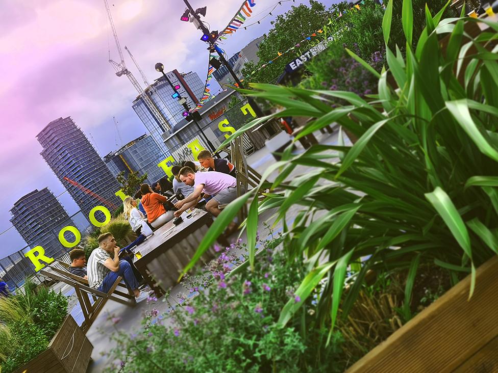 Customers drink at Roof East, Stratford, London. 4 July 2020