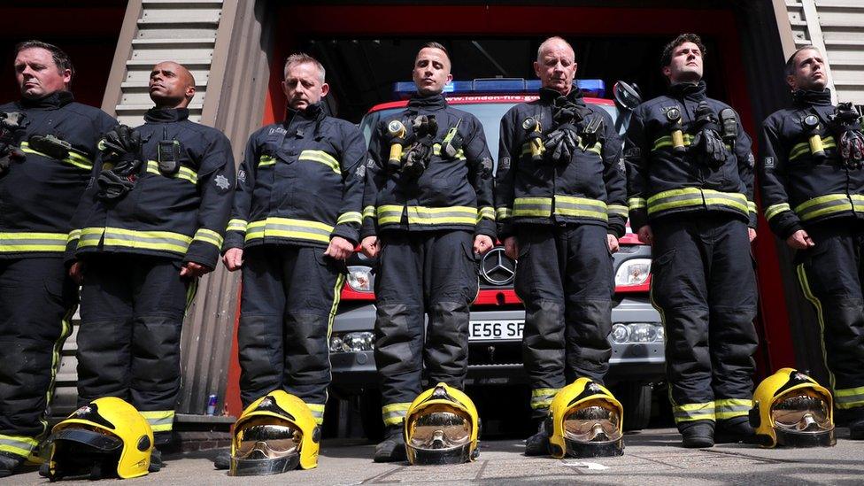 Firefighters observe a minute's silence