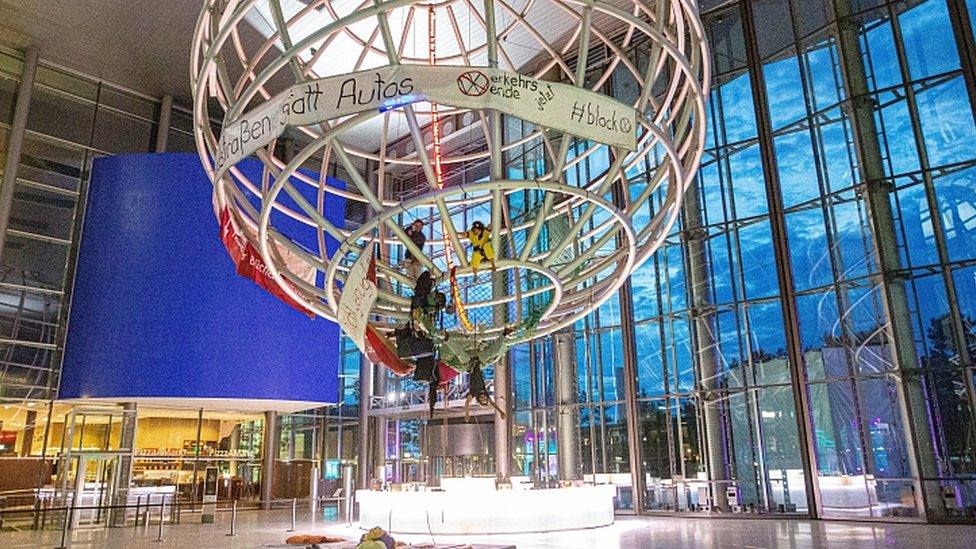 Activists occupy the globe in the lobby of the Volkswagen Autostadt in Wolfsburg, Germany, 13 August 2019