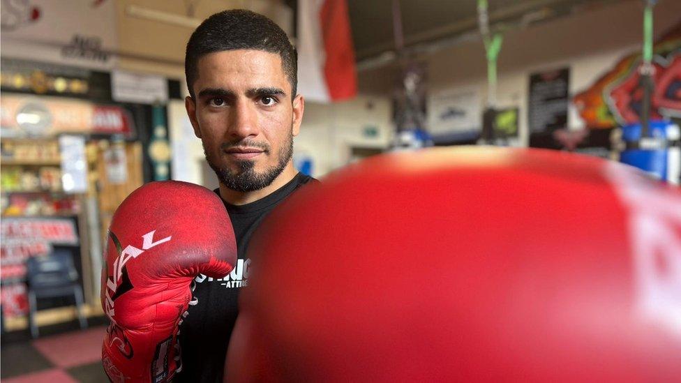 A man wearing red boxing gloves