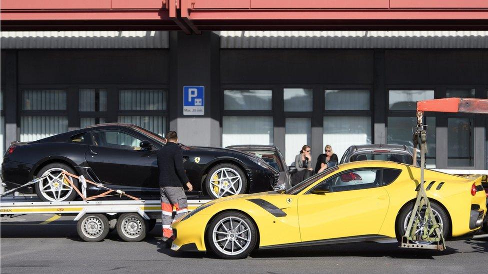 Two Ferrari sports cars belonging to Teodorin Obiang Nguema, son of Equatorial Guinea"s President, are being towed off the freight zone by the police at Geneva Airport, in Geneva, Switzerland, 03 November