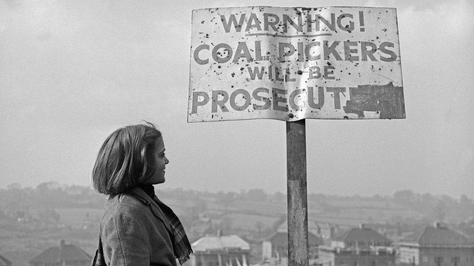 Girl next to warning sign