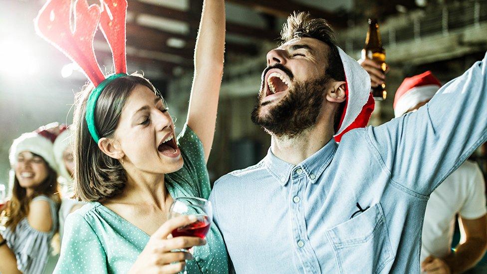 Couple singing at Christmas party