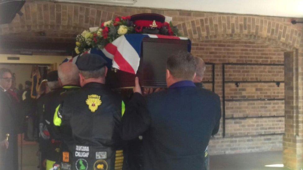 The coffin of Stewart Cooney is carried