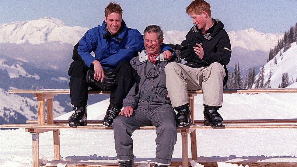 King Charles III poses with sons Prince William and Prince Harry on Madrisa during a skiing holiday in 2000.