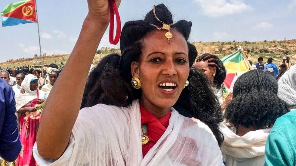 An Eritrean woman sings after crossing the border to attend the reopening border ceremony on September 11, 2018