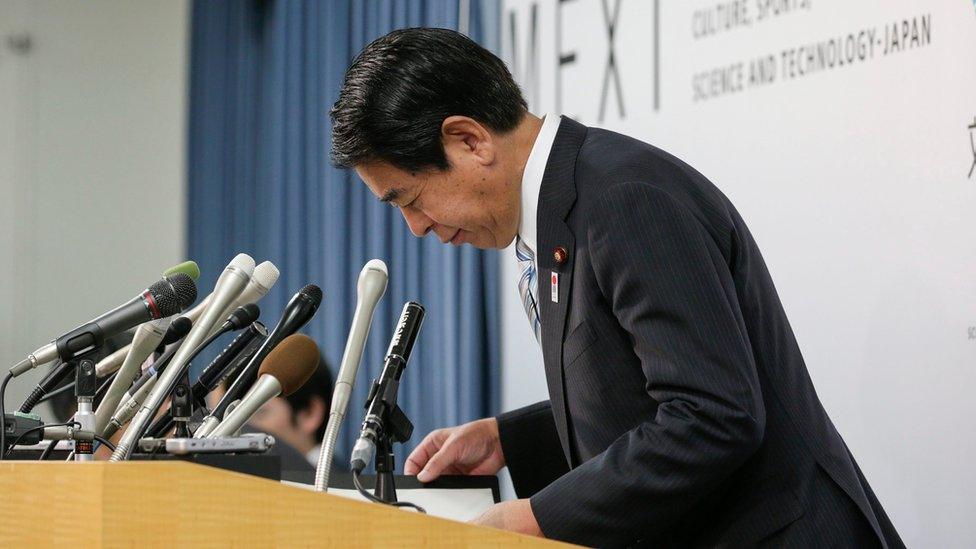 Japan's Education and Sports Minister Hakubun Shimomura bows after ending a news conference at his ministry