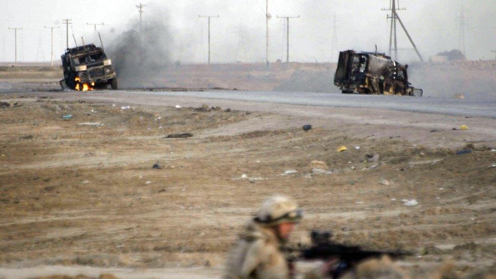 A roadside bomb goes off in Iraq - a military truck is on fire