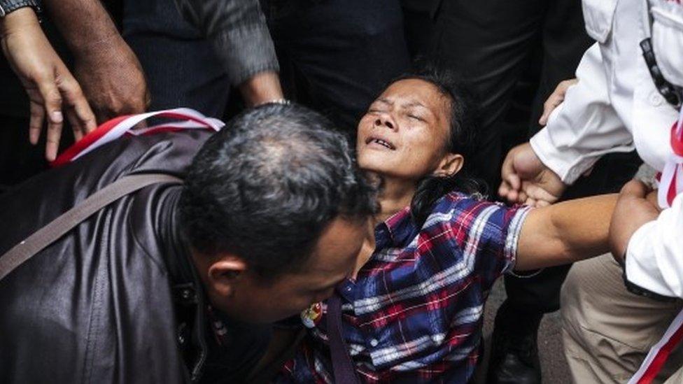 A supporter of Jakarta's Governor Basuki Tjahaja Purnama collapses after hearing news that he had been sentenced to two years in prison (09 May 2017)