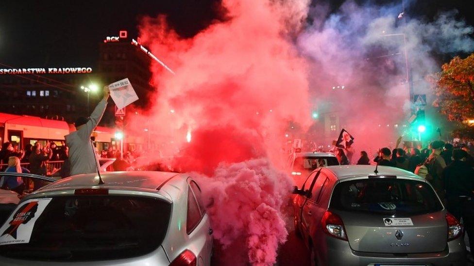 Protesters block a street in the city centre during a protest against the tightening of the abortion law in Warsaw, Poland