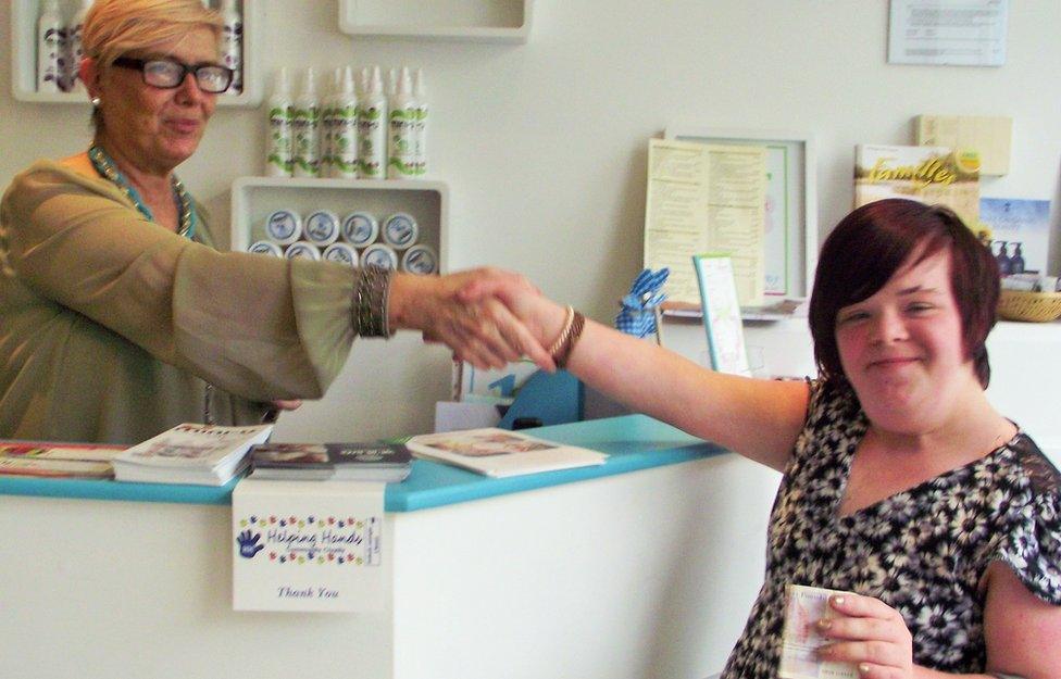 Heidi shaking hands with the owner of the salon