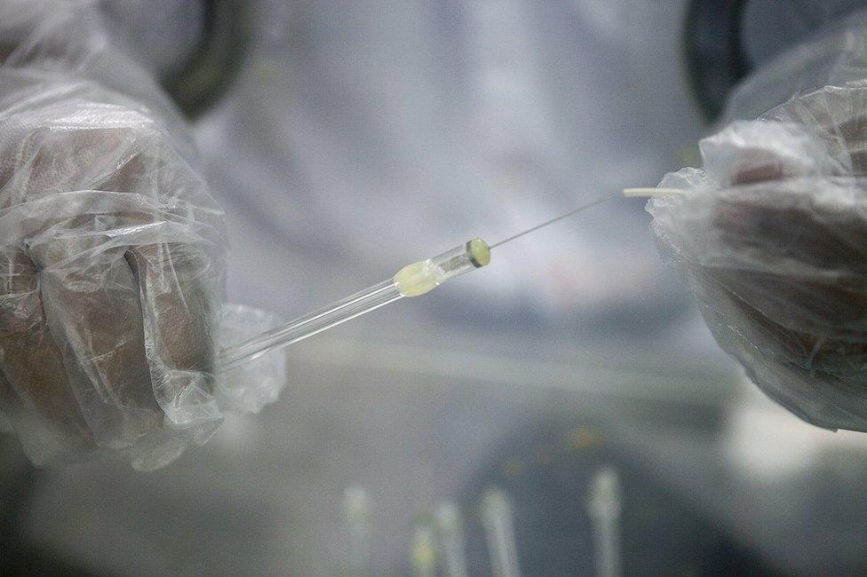 A research assistant prepares a syringe inside a pharmacy glovebox at the reversible inhibition of sperm under guidance (RISUG) male contraceptive treatment research and development laboratory at Indian Institute of Technology (IIT) Kharagpur in Kharagpur, West Bengal, India, on Feb. 16, 2017.