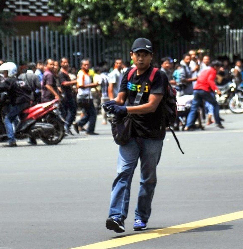 A gunman carries his weapon on the street during attacks in the Indonesian capital Jakarta on January 14, 2016.