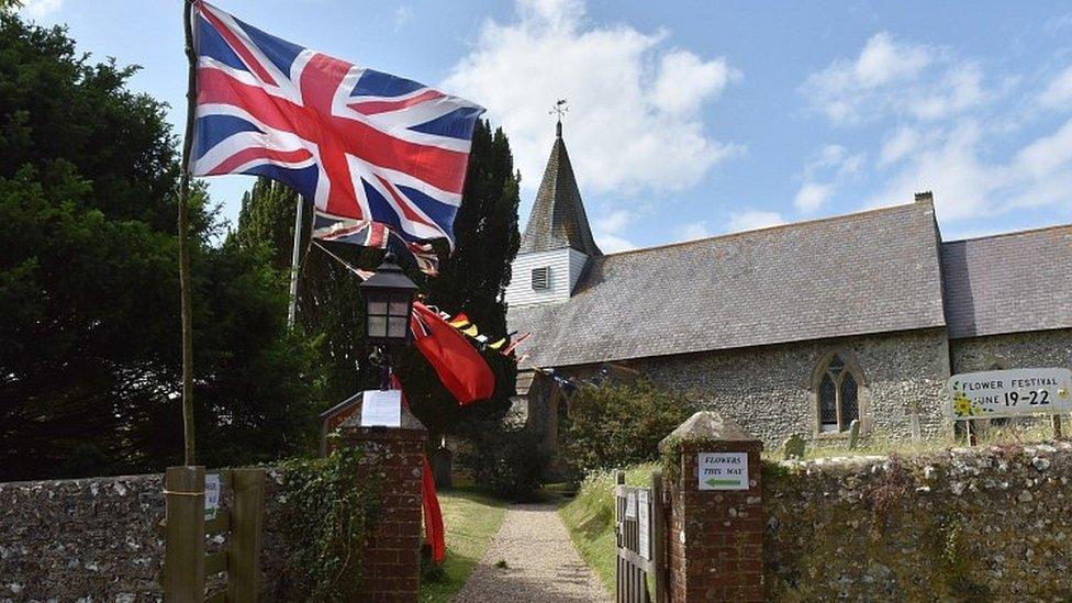 Union flag flying outside parish church in East Sussex