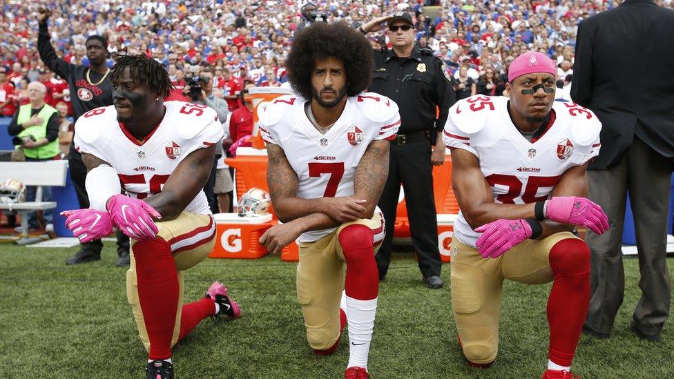 Eli Harold, Colin Kaepernick and Eric Reid kneel in protest on October 16, 2016