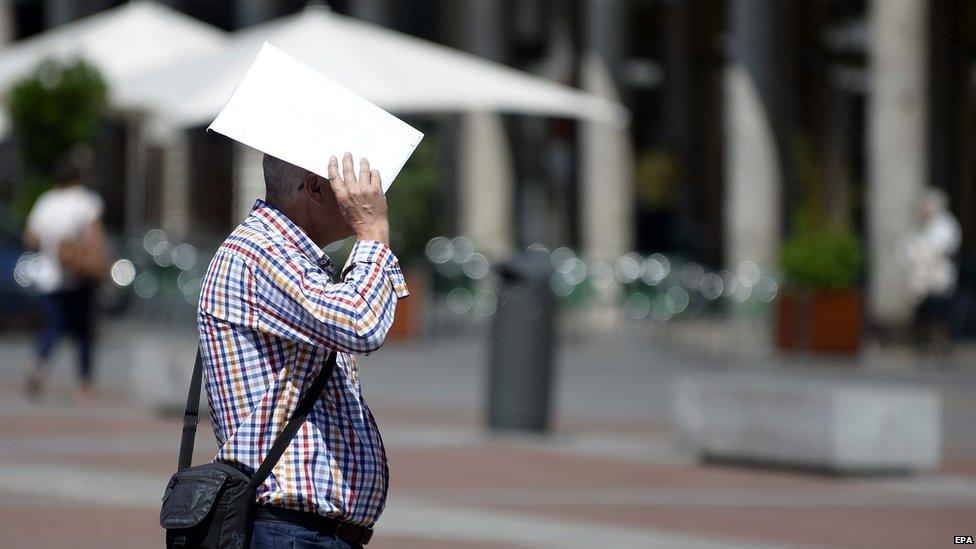 A man tries to shield from the sun rays in Valladolid, Spain, 29 June 2015.