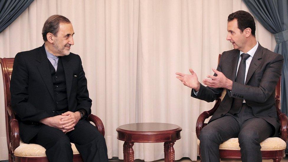 Syria's President Bashar al-Assad (R) speaks with Ali Akbar Velayati, Iran's Supreme Leader Ayatollah Ali Khamenei's top adviser on international affairs