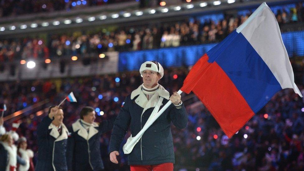 File photo taken in February 2014 shows Russia's flag bearer, bobsledder Alexander Zubkov, leading his national delegation during the Opening Ceremony of the Sochi Winter Olympics