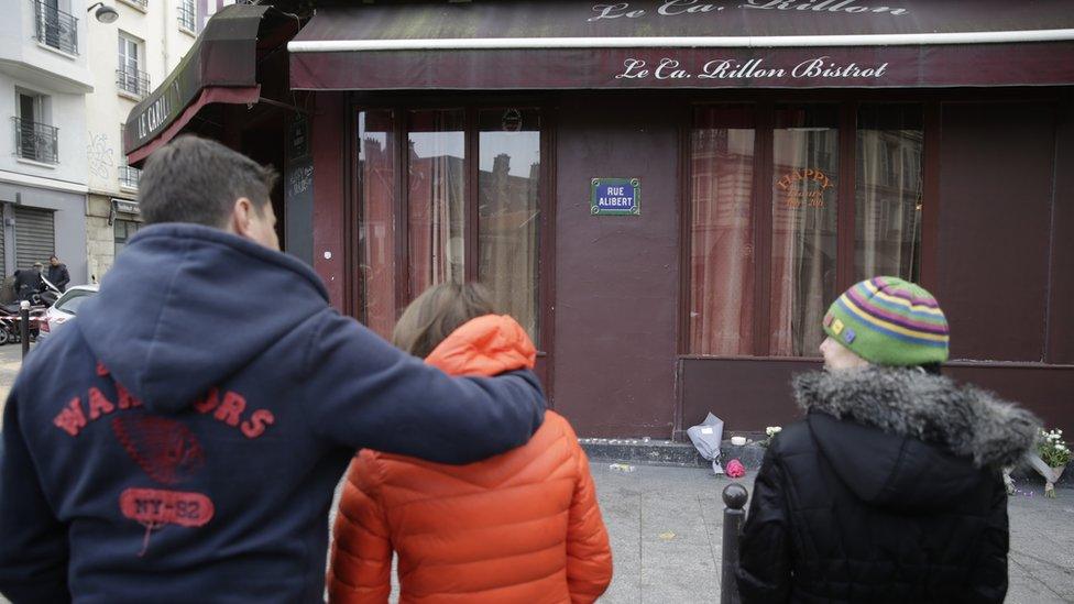 Mourners outside Carillon bar in Paris on 14 November