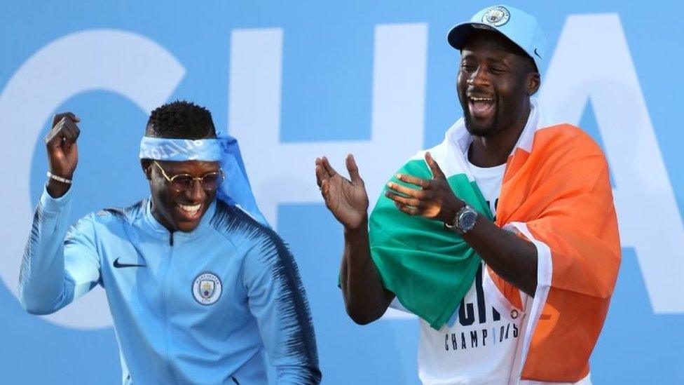 Manchester City"s Benjamin Mendy (left) and Yaya Toure