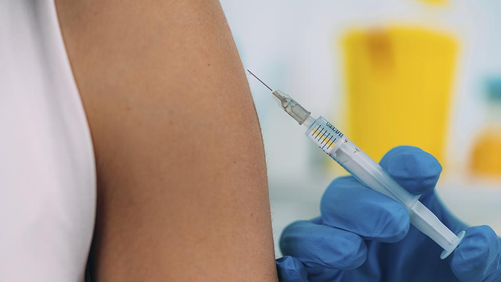 Woman receiving vaccine