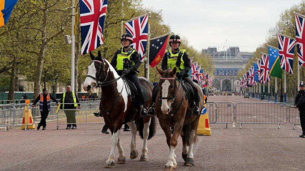 Police officers on horses patrol ahead of King Charles' coronation at the Mall