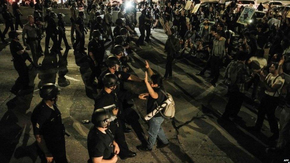 Anti-Trump protesters clash with police on a freeway in Los Angeles