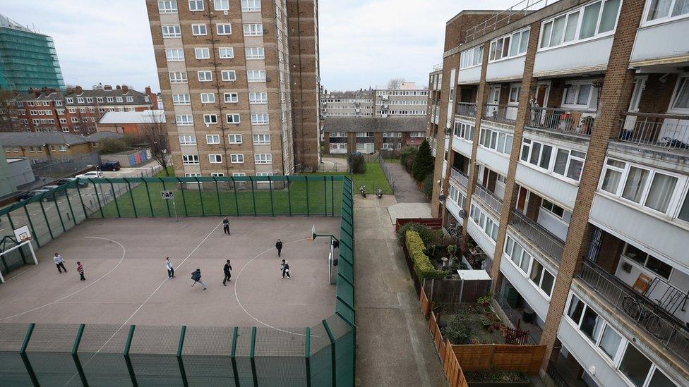 Children play a game of football in front of a residential development in the London borough of Tower Hamlets